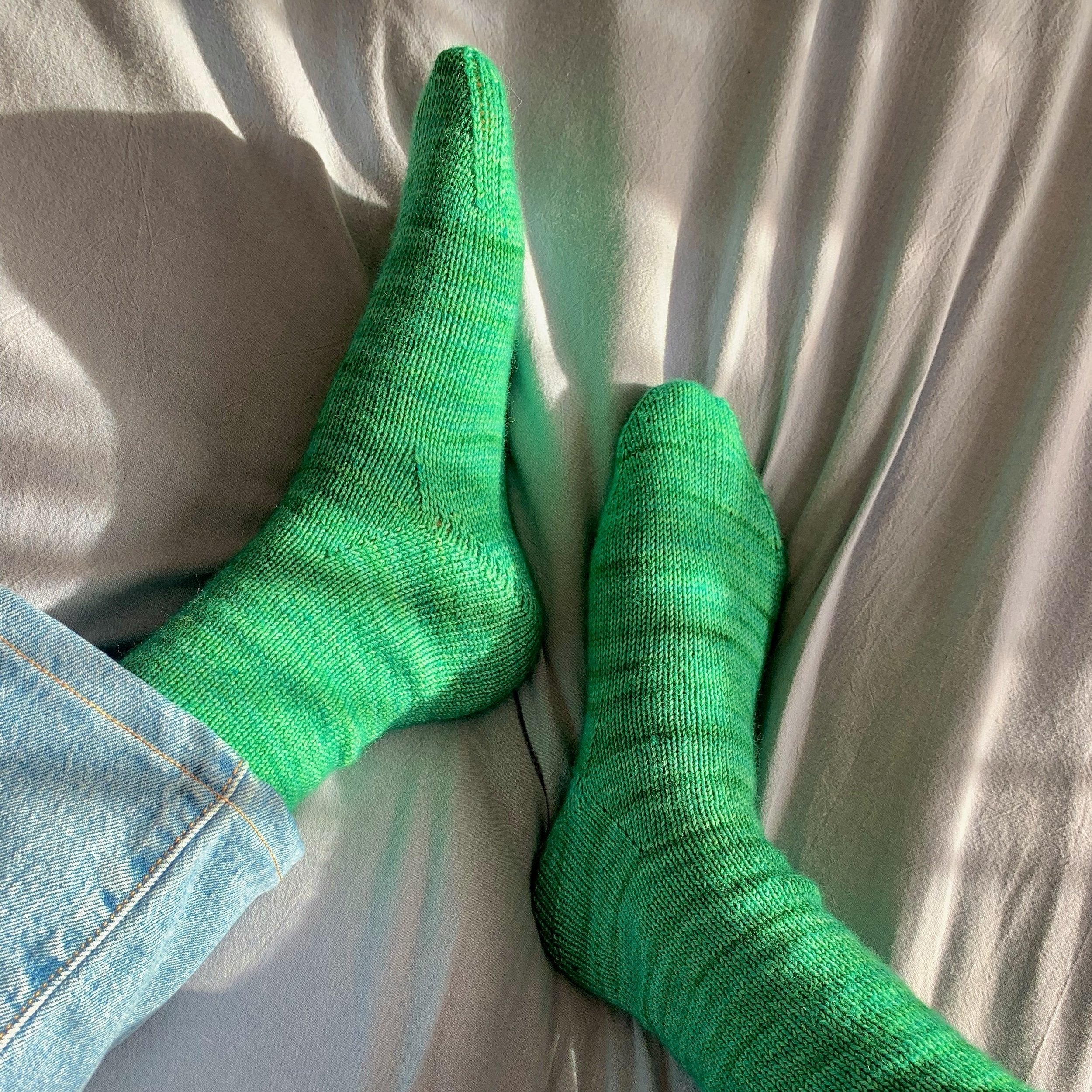 A pair of hand-knitted socks made with the Staple Sock knitting pattern