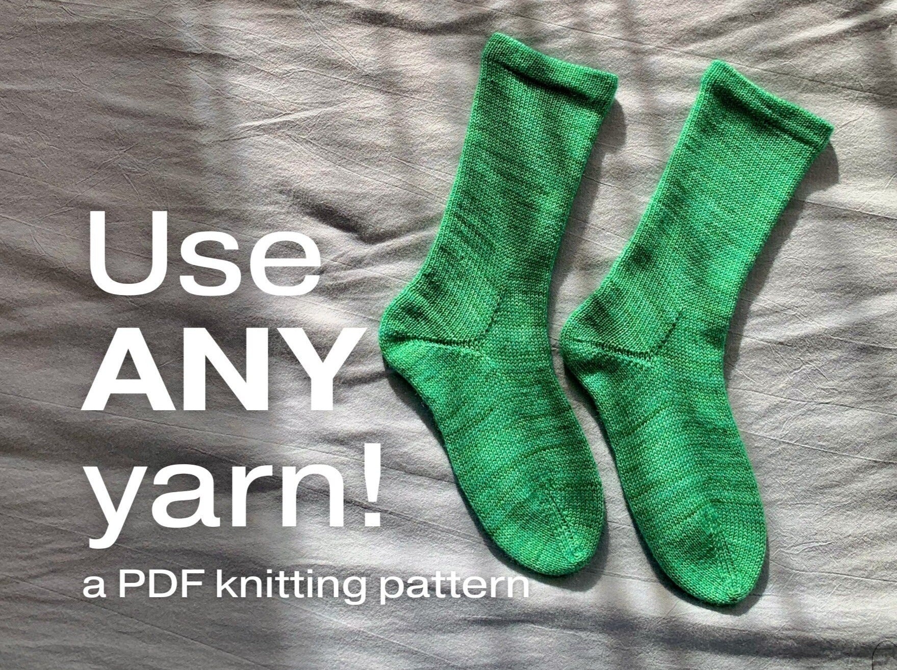 green knitted socks on a beige background with text overlay "Use ANY yarn"