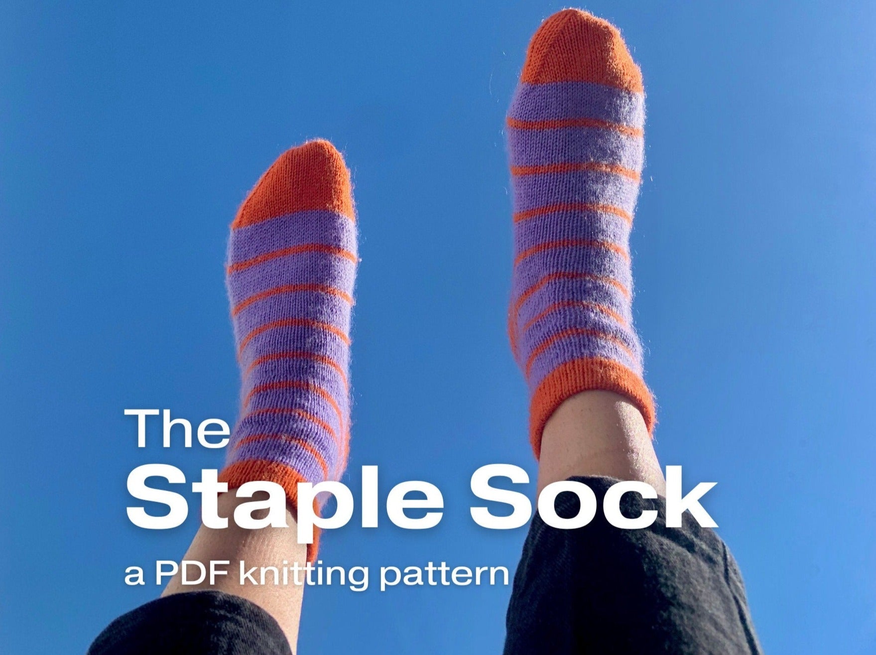 a person showcasing a striped knitted socks against a blue background