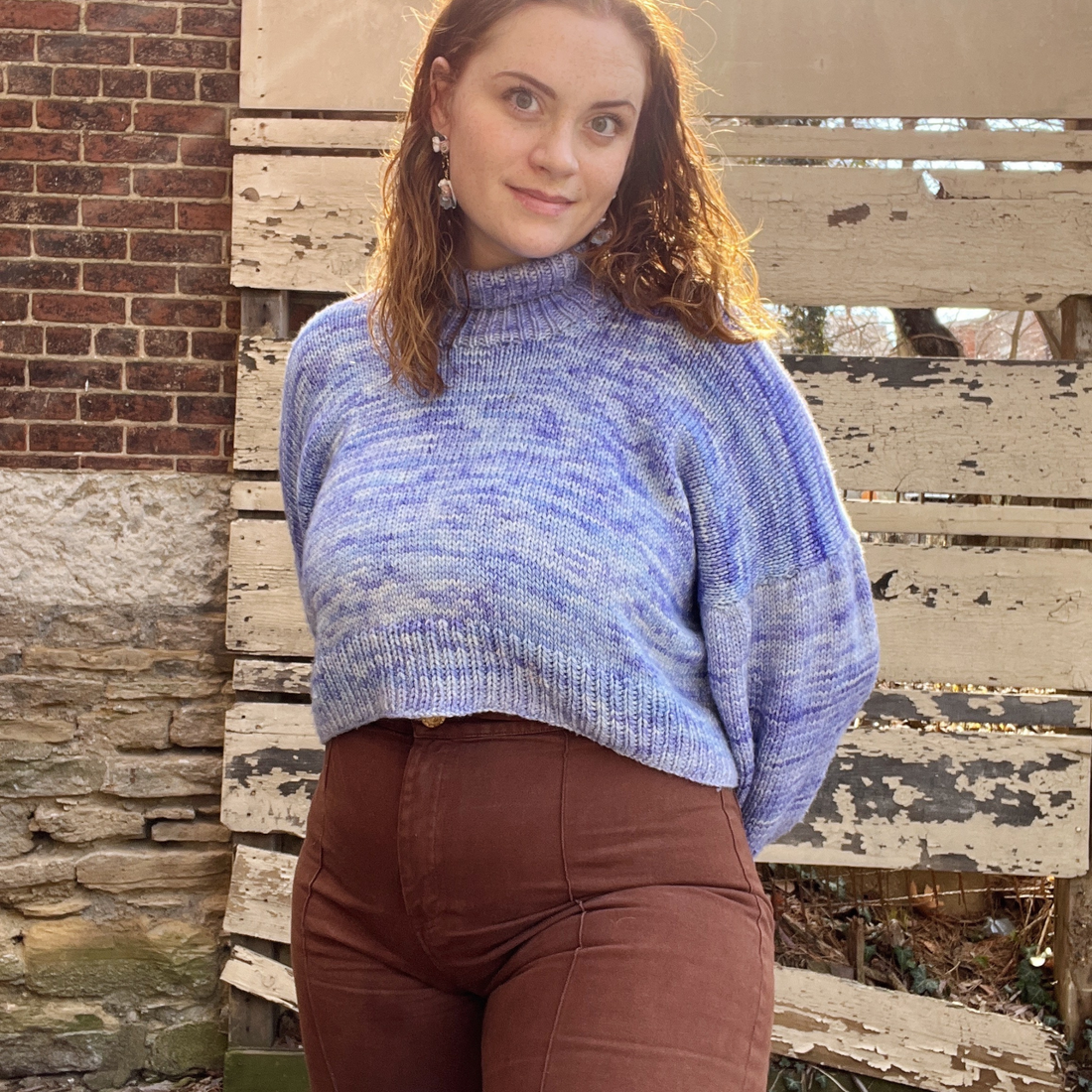 Kate Gardin of Mezzo Makes wearing a purple knitted sweater and brown pants