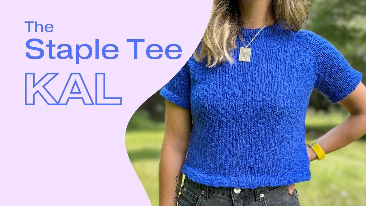 A woman wearing a hand-knit royal blue staple tee  with nature background