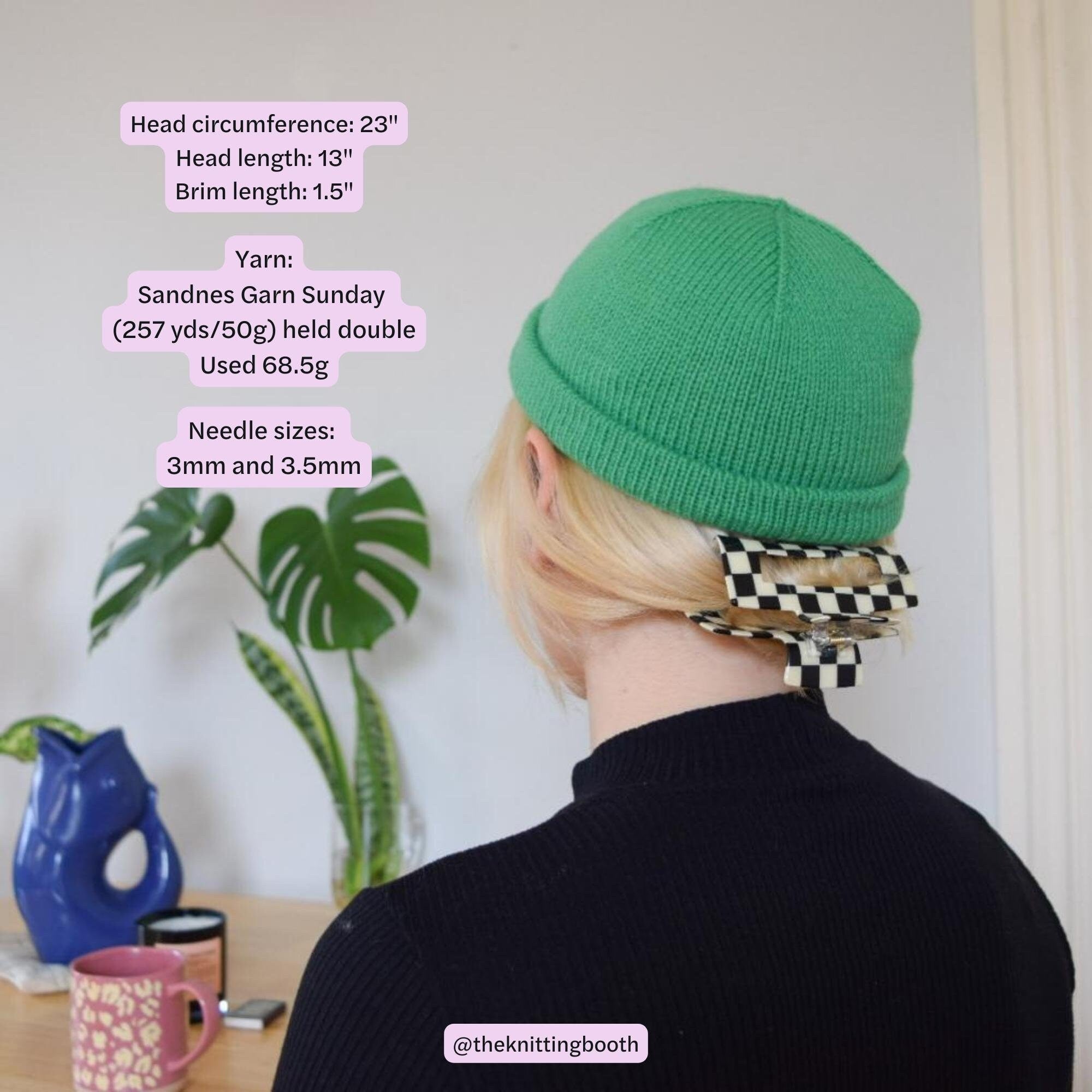 woman in a black sweater matches her outfit with a green knitted beanie