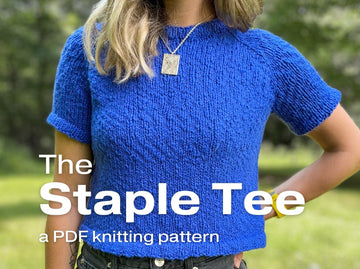 a girl showcases a blue knitted top using the Staple Tee knitting pattern 