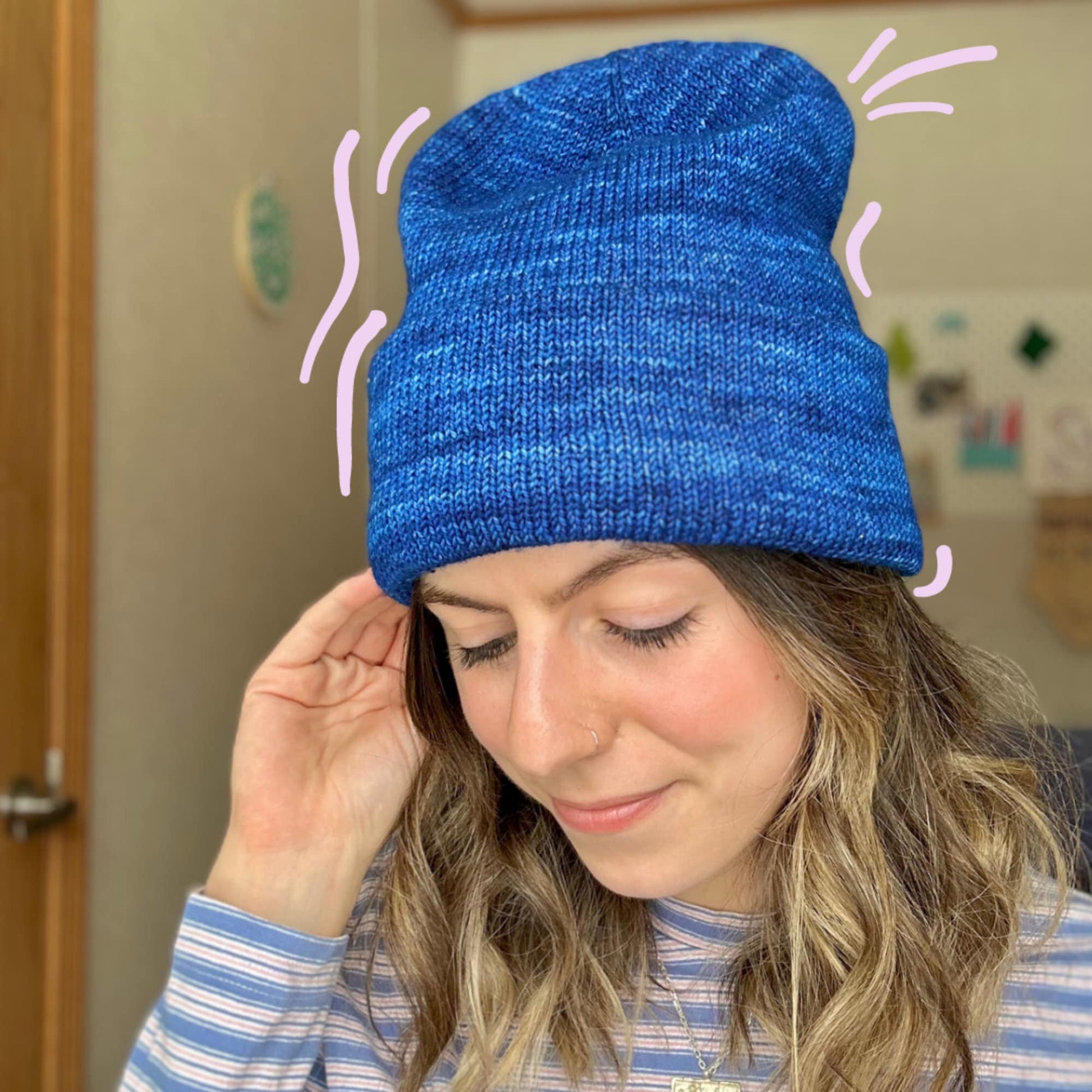 Tall Staple Beanie PDF pattern featuring a woman wearing a blue knitted hat that highlights its distinctive design.